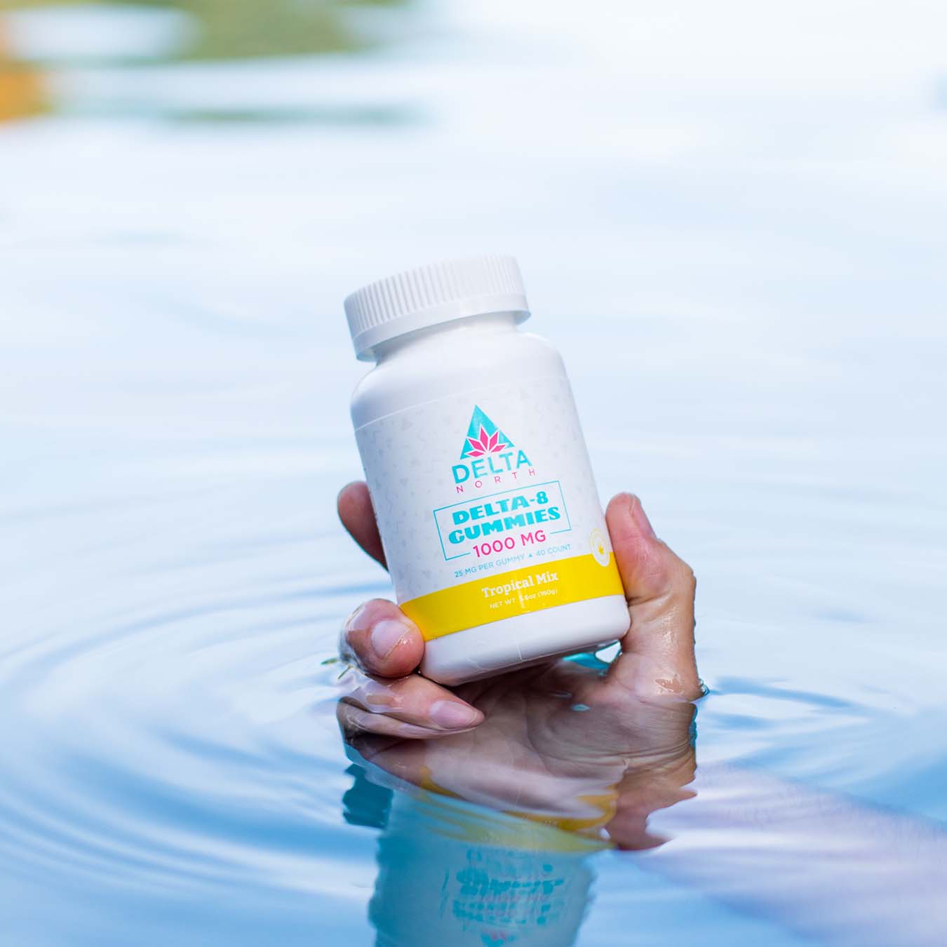 Man holding delta-8 gummies 1000 mg in hand in the water