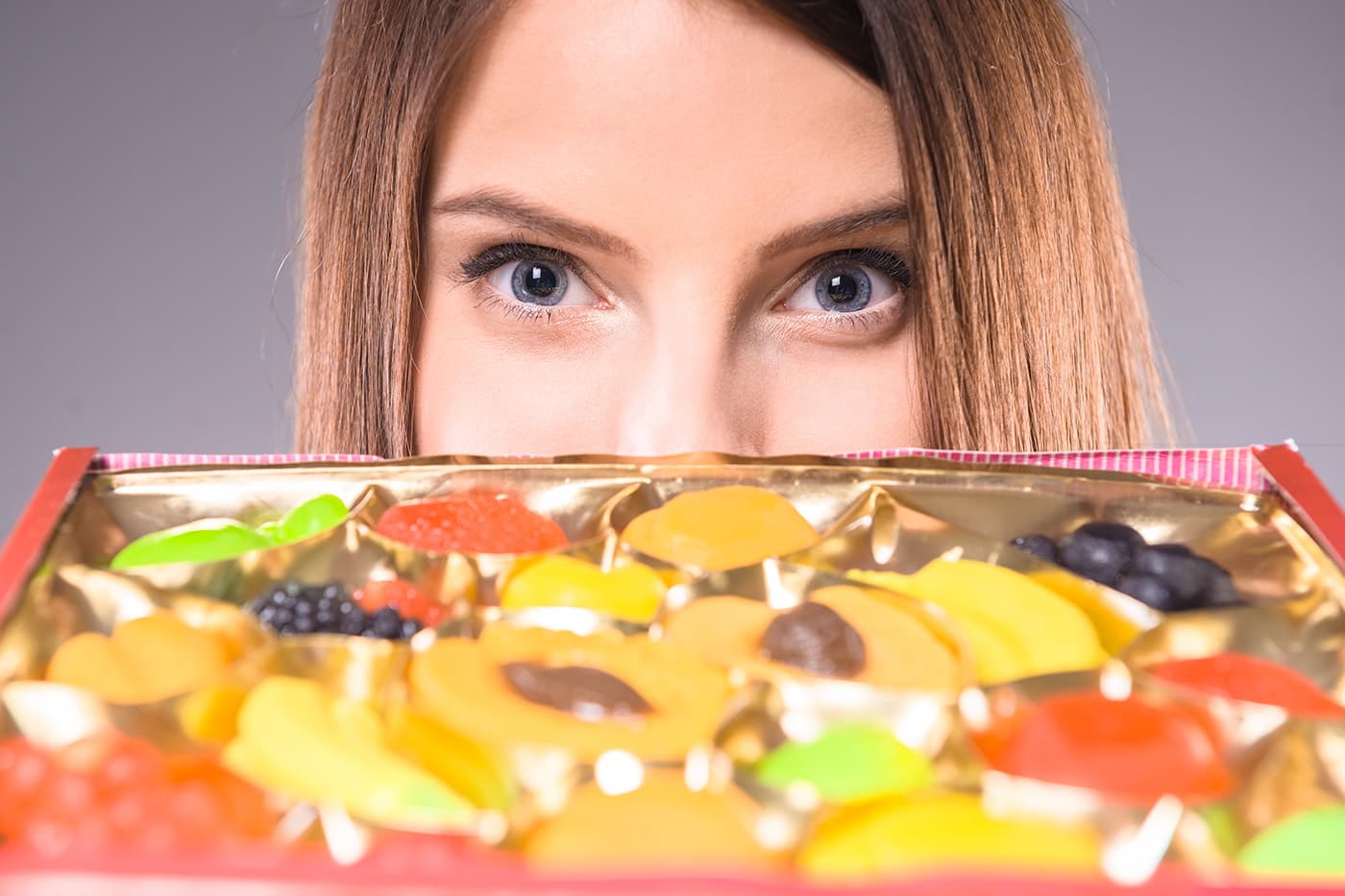 Woman looking at delta 8 gummies on sheet