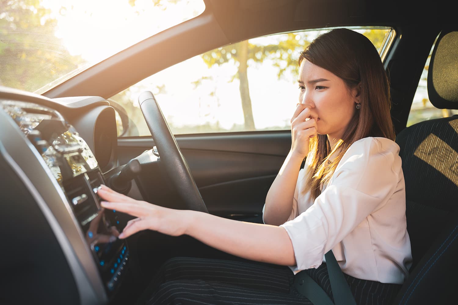 Person smelling bad weed smell in car