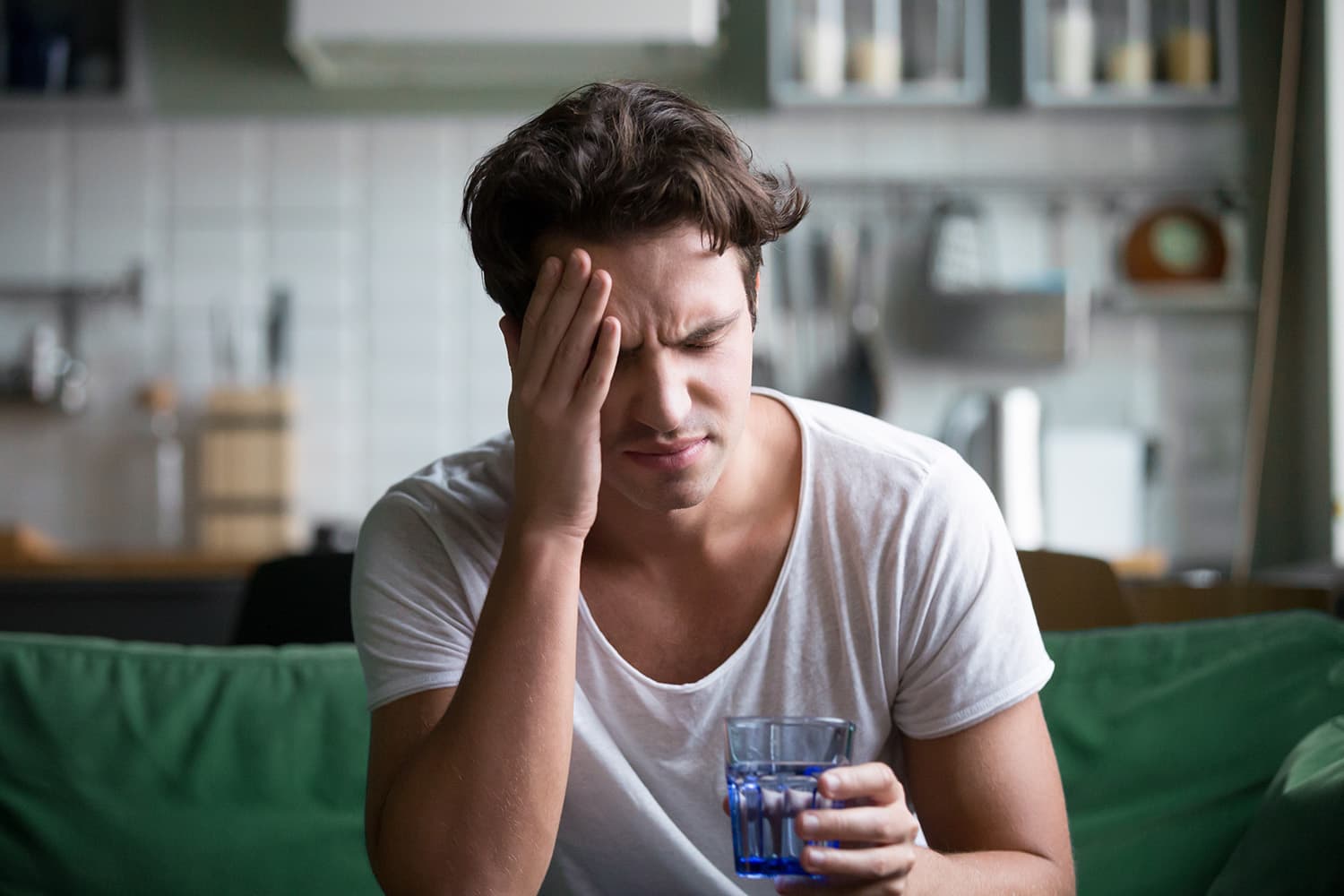 Man with delta 8 THC hangover on couch