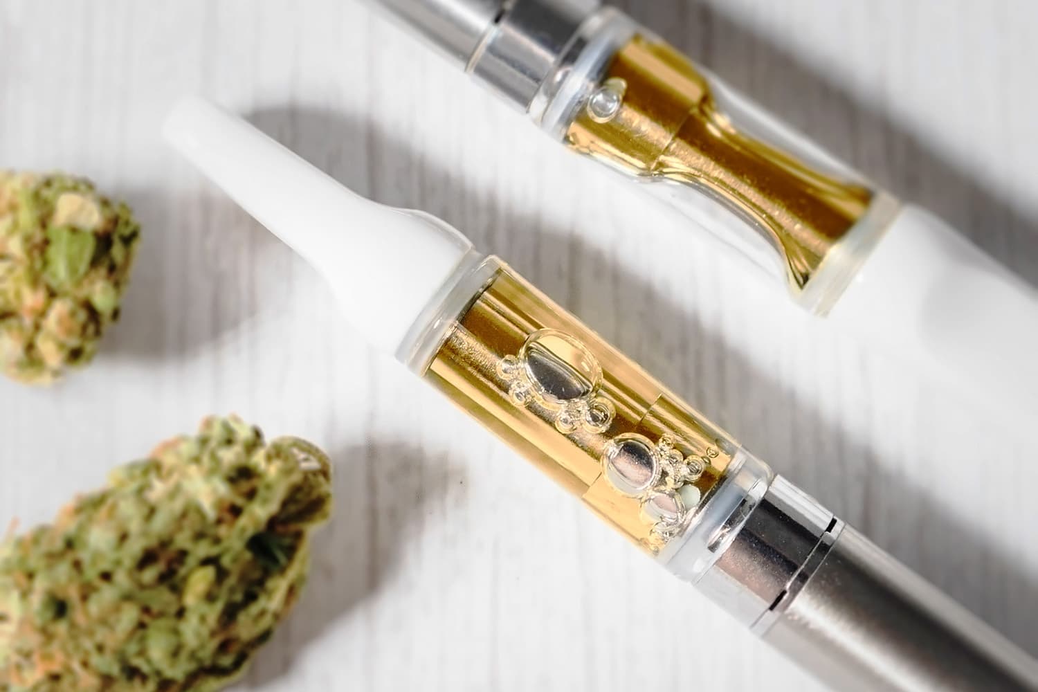 THC vape and delta 8 flower on table