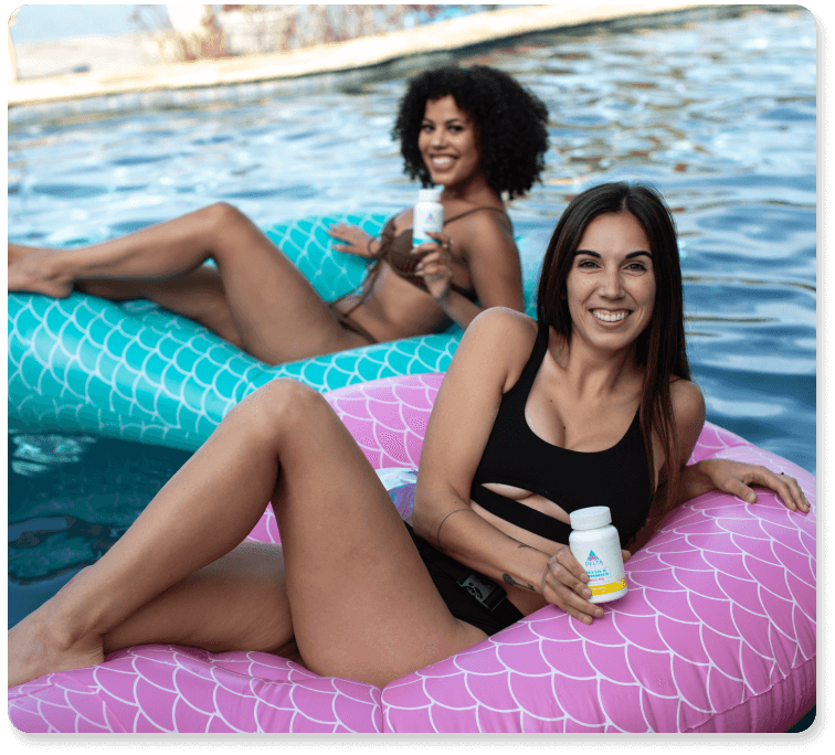 Two women holding delta 8 gummies on floats in water