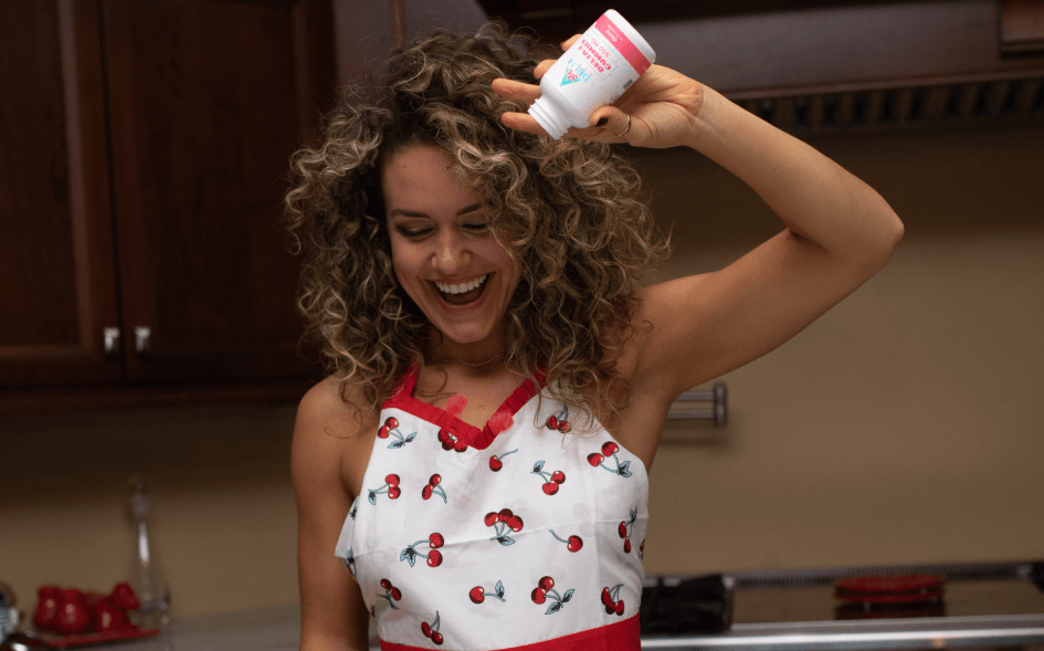 Girl pouring cherry gummies in cherry outfit