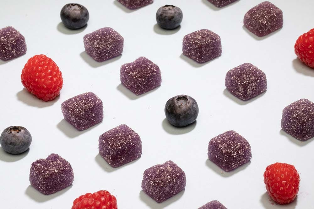 Delta-8 gummies 1000 mg with berry and blueberry on white background