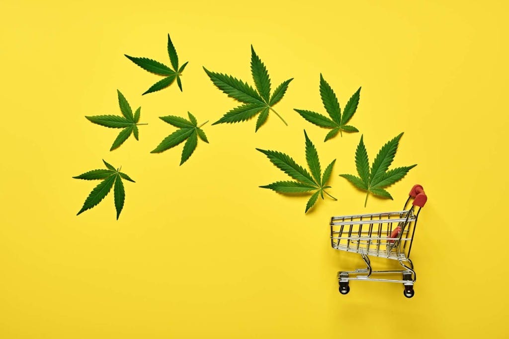 Delta-8 leaves with shopping cart and yellow background