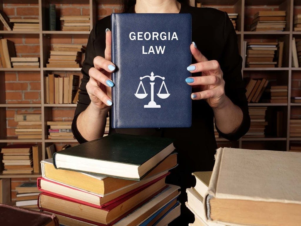 Georgia Law legal book being held in persons hands