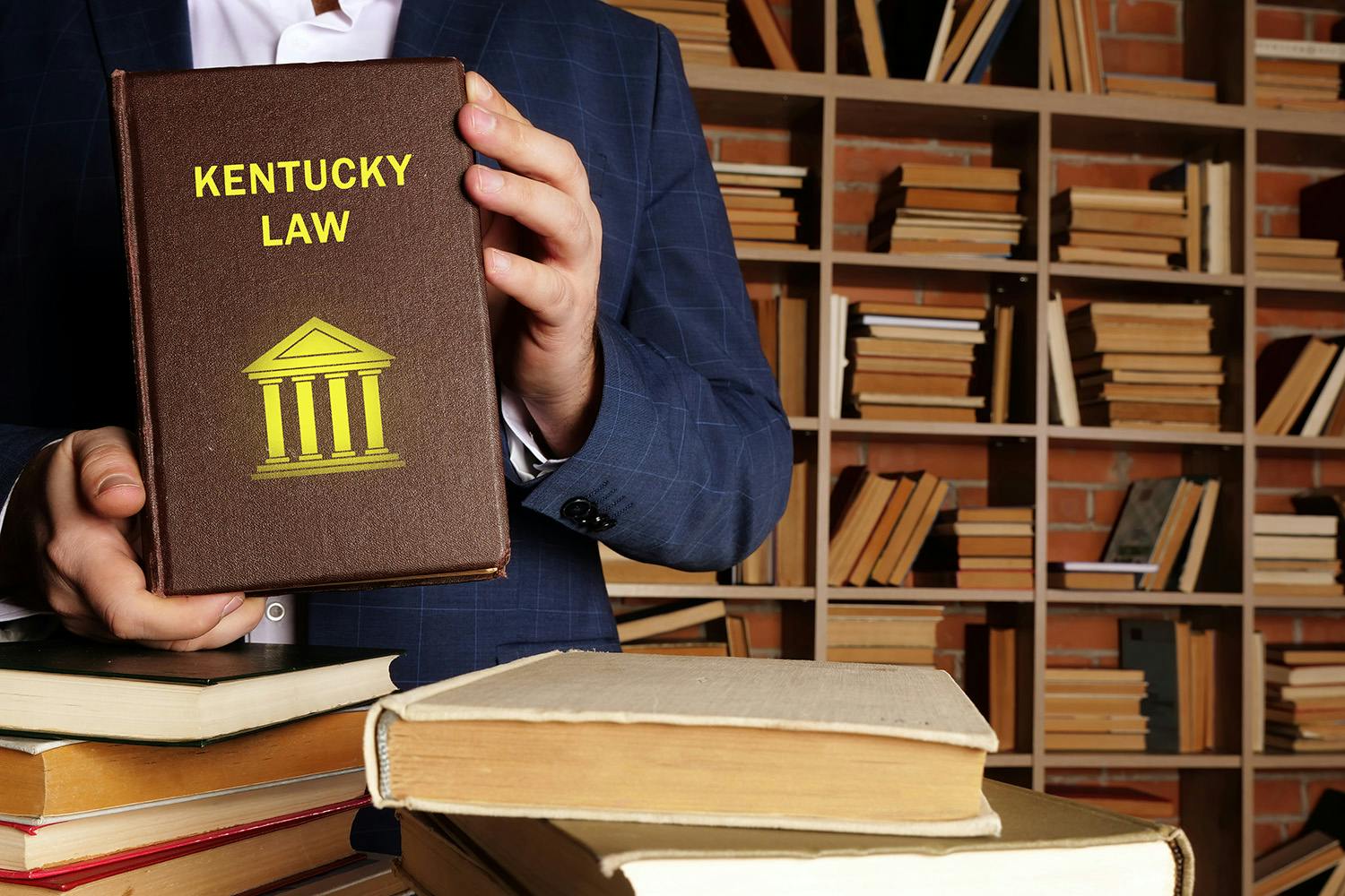 Kentucky lawyer holding legal book of Kentucky laws