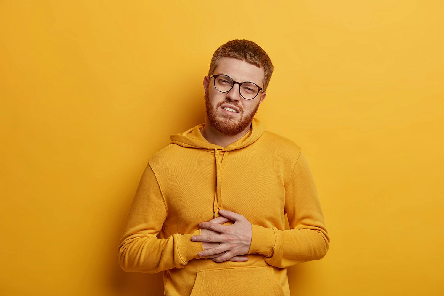Person feeling bad on yellow background