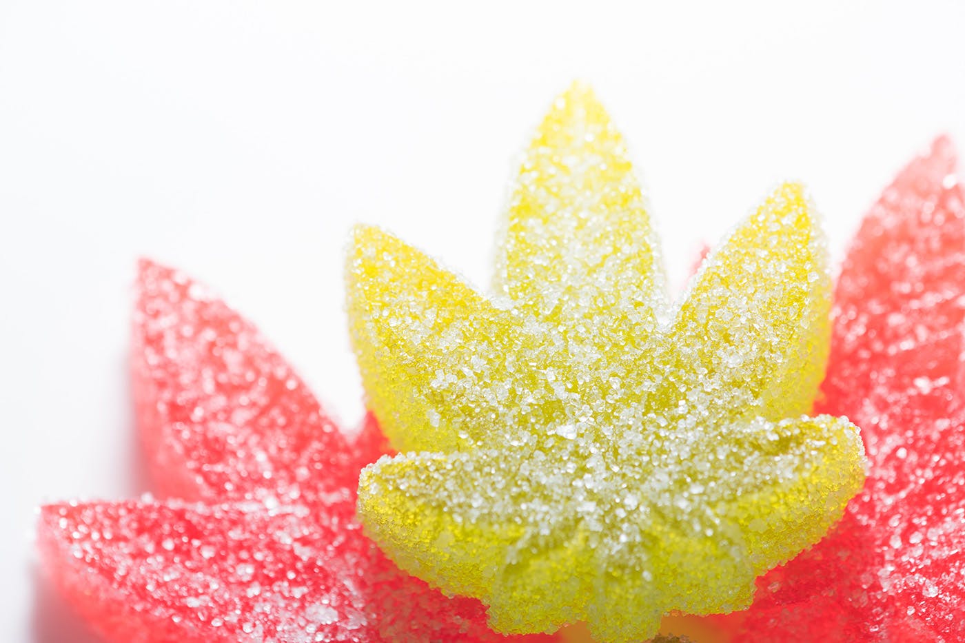 Yellow and pink delta 8 edibles on white background