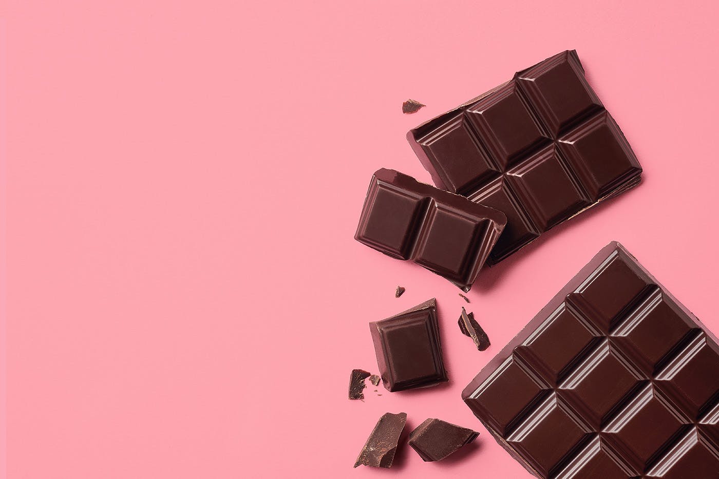 Two delta 8 chocolate edibles on pink background